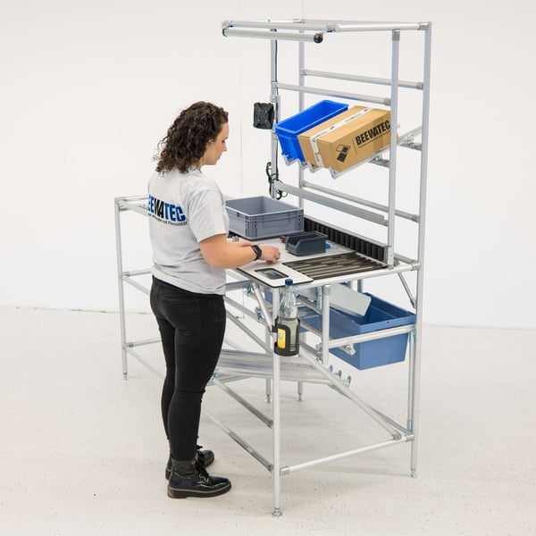 Employee works at an ergonomic height and in a healthy posture at a BeeWaTec workstation