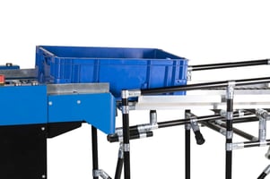 Mobile robot (BARY CM-100) transfers a box at a transfer point made of a pipe racking system