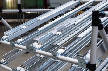 Flow rack with roller tracks and integrated brake tracks  